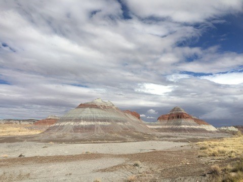 Layered desert hills beneath dramatic clouds